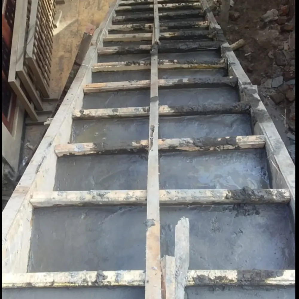 Freshly cast concrete stairs inside timber formwork