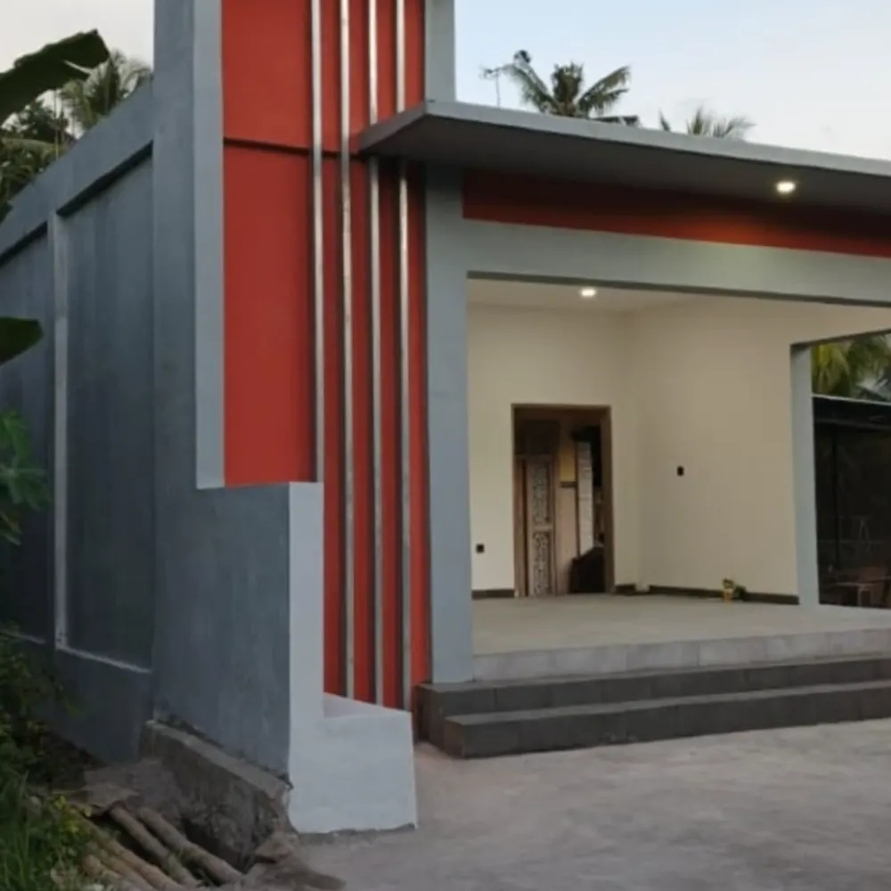 Finished single-storey building with red vertical fins, grey walls and an open front